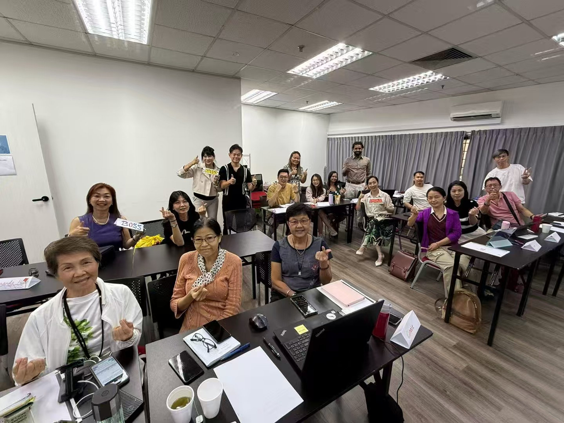 Participants in AI training workshop giving thumbs up